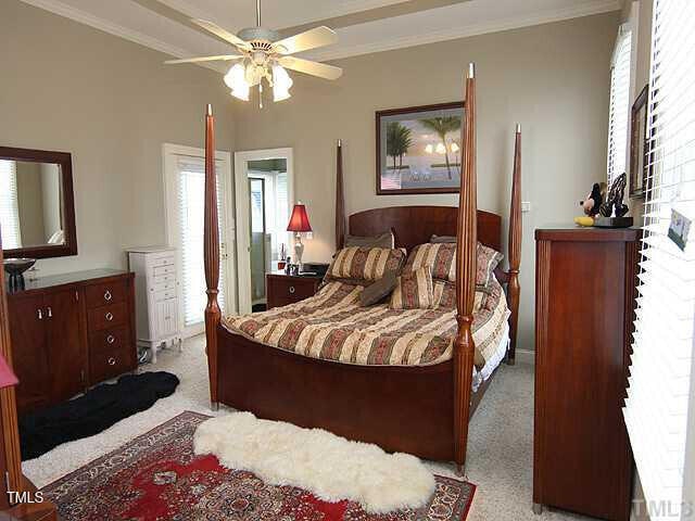 100 Lager Ln, Garner, NC 27529 - bedroom featuring crown molding, light carpet, and a ceiling fan