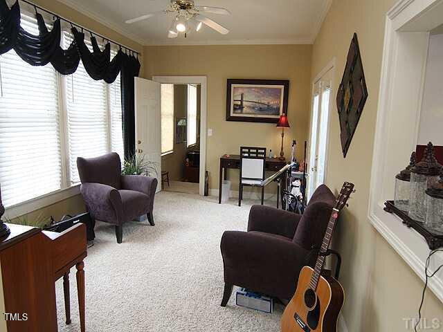 100 Lager Ln, Garner, NC 27529 - carpeted living room featuring ceiling fan and ornamental molding