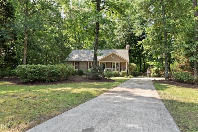 6009 Shadow Moss Cir, Raleigh, NC 27603 - view of front of home with a porch, driveway, a chimney, and a front yard