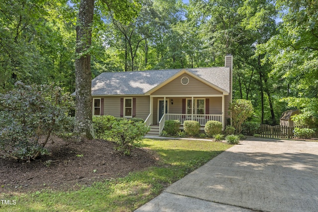 6009 Shadow Moss Cir, Raleigh, NC 27603 - view of front facade featuring a porch, a chimney, a shingled roof, and driveway