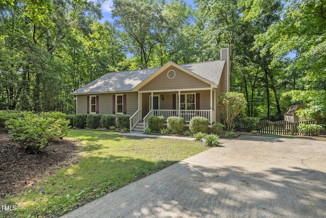 6009 Shadow Moss Cir, Raleigh, NC 27603 - ranch-style house with a porch, a chimney, and a shingled roof