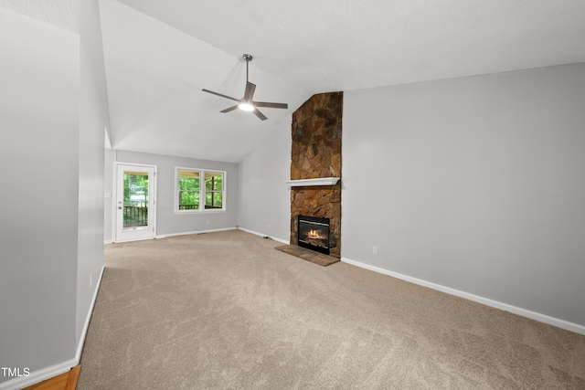 6009 Shadow Moss Cir, Raleigh, NC 27603 - unfurnished living room with carpet floors, a stone fireplace, ceiling fan, baseboards, and vaulted ceiling