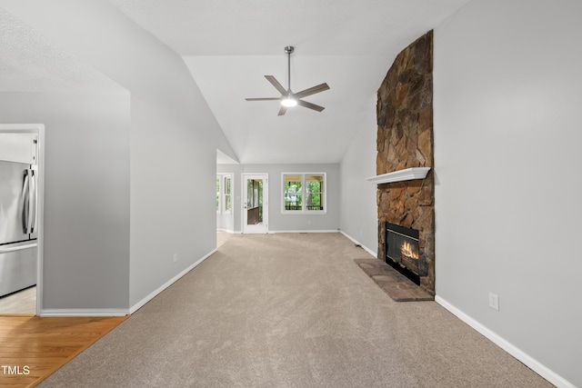 6009 Shadow Moss Cir, Raleigh, NC 27603 - unfurnished living room featuring a fireplace, a ceiling fan, baseboards, lofted ceiling, and carpet flooring
