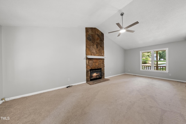 6009 Shadow Moss Cir, Raleigh, NC 27603 - unfurnished living room with a ceiling fan, a stone fireplace, carpet flooring, lofted ceiling, and baseboards