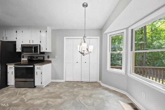 6009 Shadow Moss Cir, Raleigh, NC 27603 - kitchen featuring appliances with stainless steel finishes, plenty of natural light, and white cabinetry