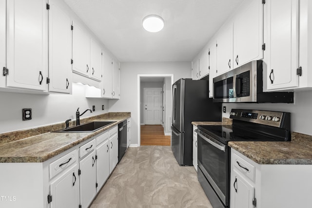 6009 Shadow Moss Cir, Raleigh, NC 27603 - kitchen featuring stainless steel appliances, a sink, white cabinets, and baseboards