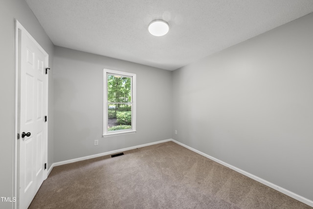 6009 Shadow Moss Cir, Raleigh, NC 27603 - carpeted spare room featuring baseboards and a textured ceiling