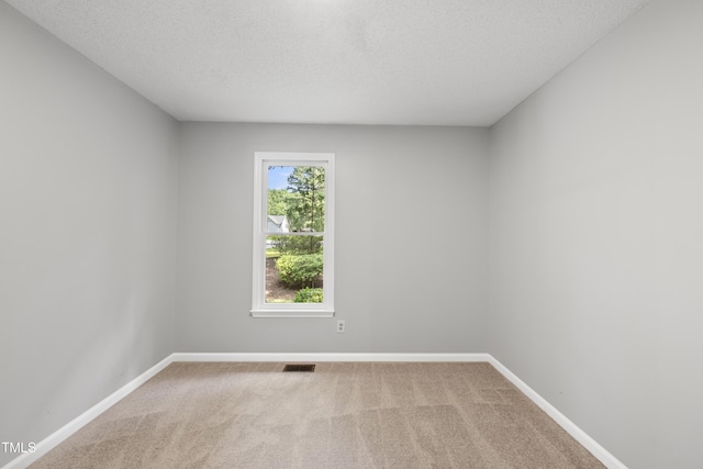 6009 Shadow Moss Cir, Raleigh, NC 27603 - carpeted spare room with a textured ceiling and baseboards