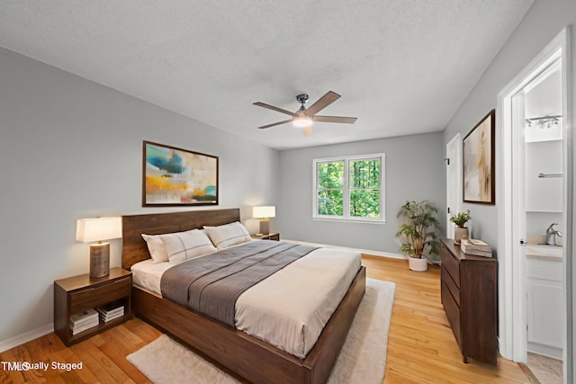 6009 Shadow Moss Cir, Raleigh, NC 27603 - bedroom with light wood-style flooring, baseboards, and a ceiling fan