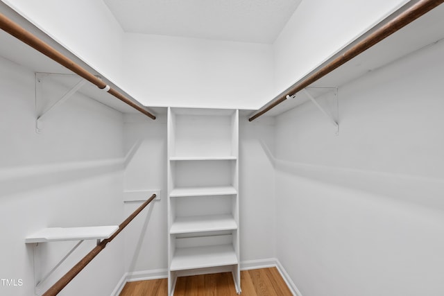 6009 Shadow Moss Cir, Raleigh, NC 27603 - spacious closet with wood finished floors