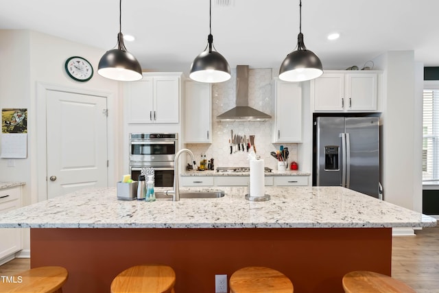 6928 Leesville Rd, Raleigh, NC 27613 - kitchen with stainless steel appliances, wall chimney exhaust hood, a kitchen bar, white cabinetry, and backsplash