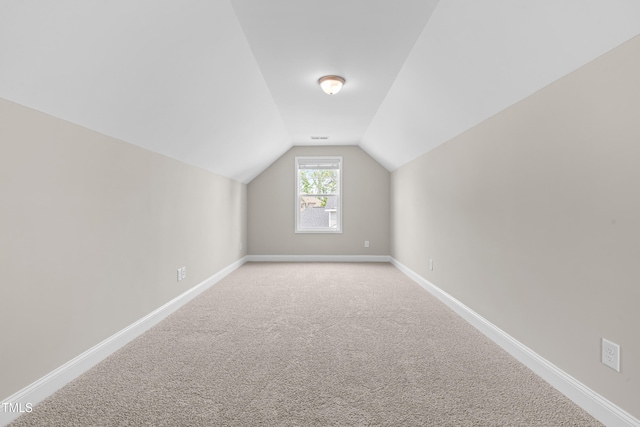 33 E Ravano Dr, Clayton, NC 27527 - additional living space with vaulted ceiling, baseboards, and carpet flooring