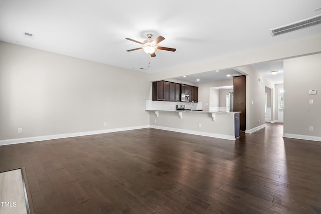 33 E Ravano Dr, Clayton, NC 27527 - unfurnished living room with ceiling fan, dark wood finished floors, baseboards, a sink, and recessed lighting