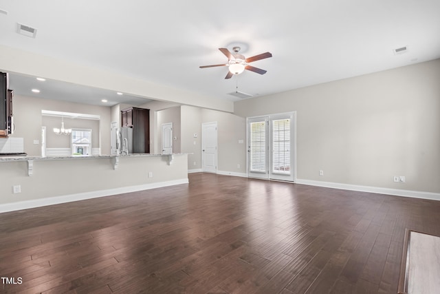 33 E Ravano Dr, Clayton, NC 27527 - unfurnished living room with a ceiling fan, dark wood finished floors, a chandelier, healthy amount of natural light, and recessed lighting