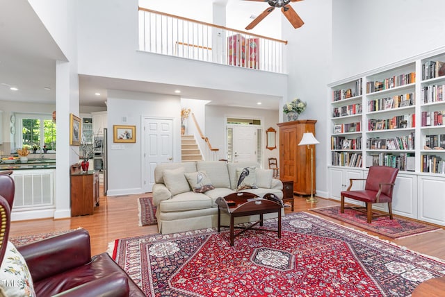 850 N Langdon, Pittsboro, NC 27312 - living area featuring a ceiling fan, wood finished floors, stairway, a high ceiling, and baseboards