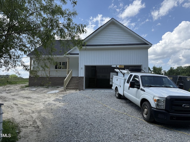168 Clayton Rd, Princeton, NC 27569 - view of front facade with covered porch, an attached garage, and stairway