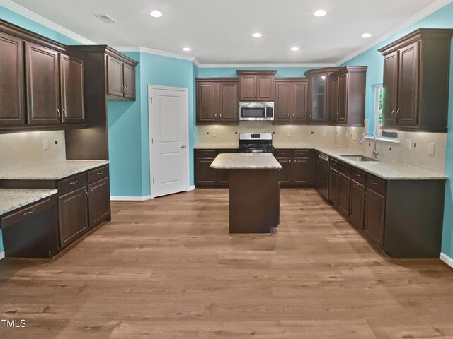 617 Hiddenbrook Dr, Durham, NC 27703 - kitchen with stainless steel appliances, a sink, ornamental molding, tasteful backsplash, and dark brown cabinets