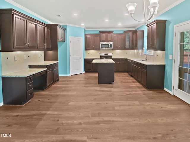 617 Hiddenbrook Dr, Durham, NC 27703 - kitchen with stainless steel appliances, a sink, ornamental molding, a center island, and a chandelier