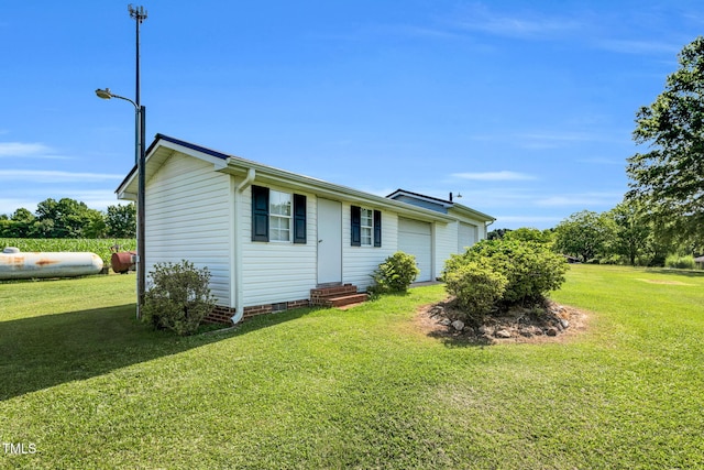 6080 US-421 N, Lillington, NC 27546 - view of property exterior with entry steps, a garage, and a yard