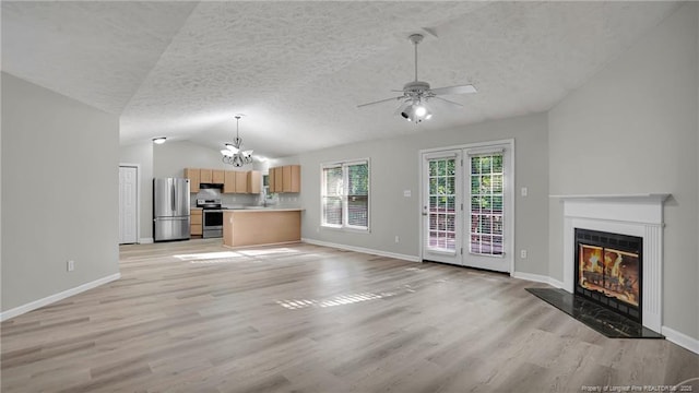 21 Dinghy Dr, Sanford, NC 27332 - unfurnished living room featuring a chandelier, lofted ceiling, a glass covered fireplace, a textured ceiling, and light wood finished floors