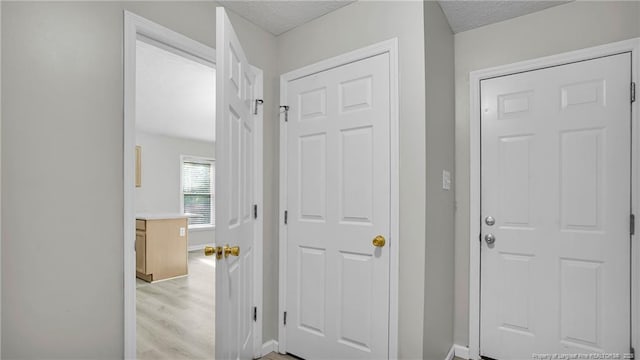 21 Dinghy Dr, Sanford, NC 27332 - hallway featuring light wood-type flooring, baseboards, and a textured ceiling