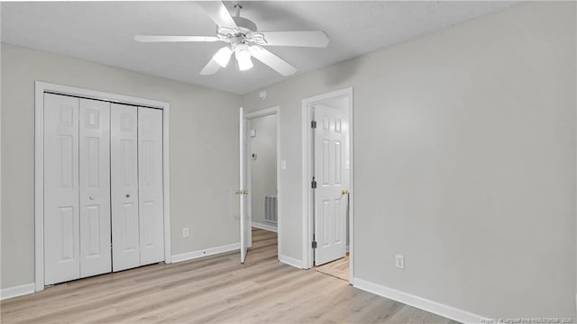 21 Dinghy Dr, Sanford, NC 27332 - unfurnished bedroom with light wood finished floors, baseboards, a closet, and a ceiling fan