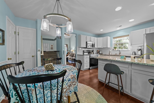 34 Tannenbaum Cir, Greensboro, NC 27410 - dining space with dark wood-style floors and recessed lighting