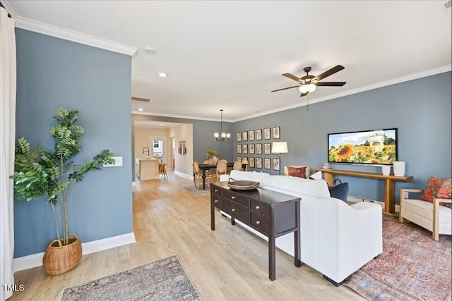 209 Broomgrove Way, Wake Forest, NC 27587 - living area featuring baseboards, light wood-style flooring, ceiling fan, ornamental molding, and a chandelier
