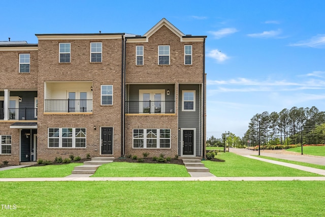 209 Broomgrove Way, Wake Forest, NC 27587 - townhome / multi-family property with a front yard and brick siding