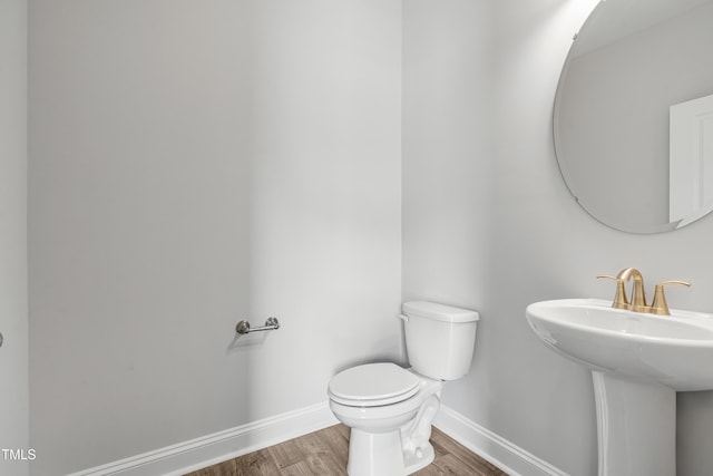 209 Broomgrove Way, Wake Forest, NC 27587 - bathroom with baseboards, wood finished floors, toilet, and a sink