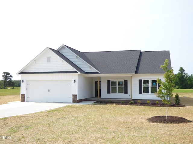 614 Tart Town Rd, Dunn, NC 28334 - view of front of home with an attached garage, concrete driveway, a front yard, and covered porch
