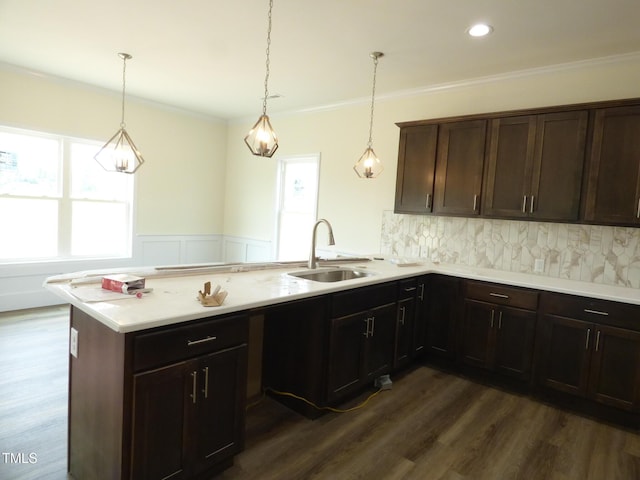 614 Tart Town Rd, Dunn, NC 28334 - kitchen featuring a sink, a peninsula, light countertops, a wainscoted wall, and dark wood finished floors
