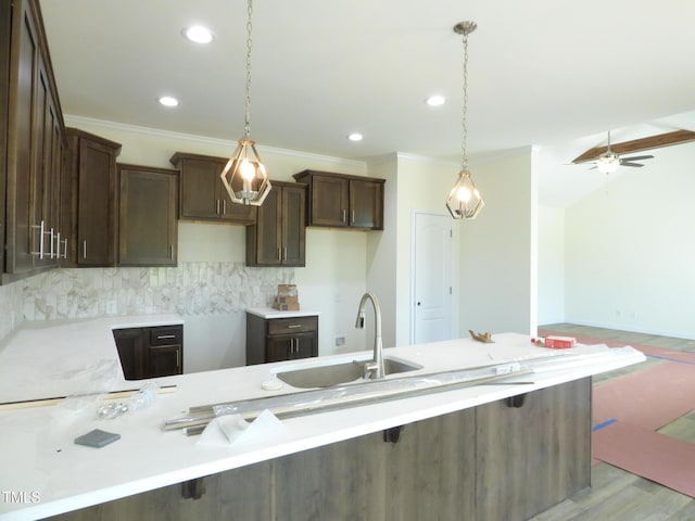 614 Tart Town Rd, Dunn, NC 28334 - kitchen featuring a sink, dark brown cabinetry, recessed lighting, tasteful backsplash, and decorative light fixtures