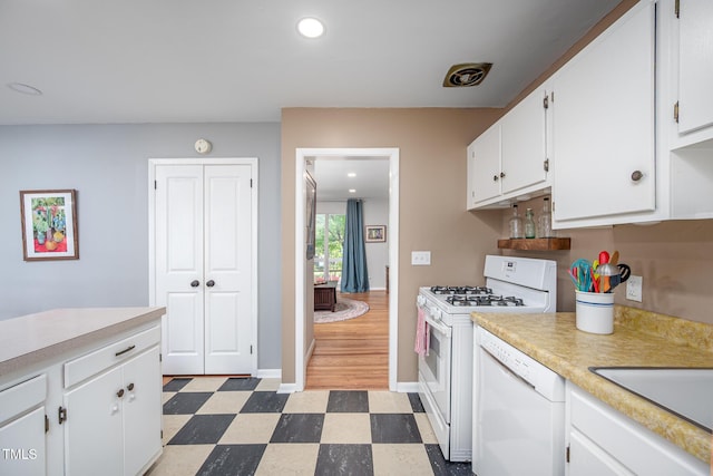 903 W Maynard Ave, Durham, NC 27704 - kitchen with white appliances, tile patterned floors, light countertops, white cabinets, and recessed lighting