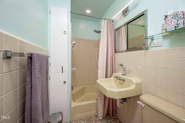 903 W Maynard Ave, Durham, NC 27704 - bathroom with tile walls, toilet, shower / bath combo with shower curtain, a sink, and wainscoting
