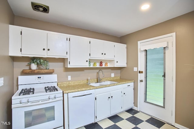 903 W Maynard Ave, Durham, NC 27704 - kitchen featuring white appliances, light floors, light countertops, and white cabinets