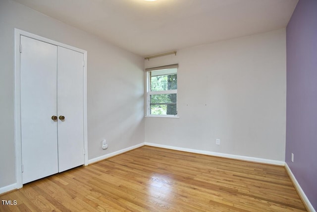 903 W Maynard Ave, Durham, NC 27704 - unfurnished bedroom with light wood-style floors and a closet