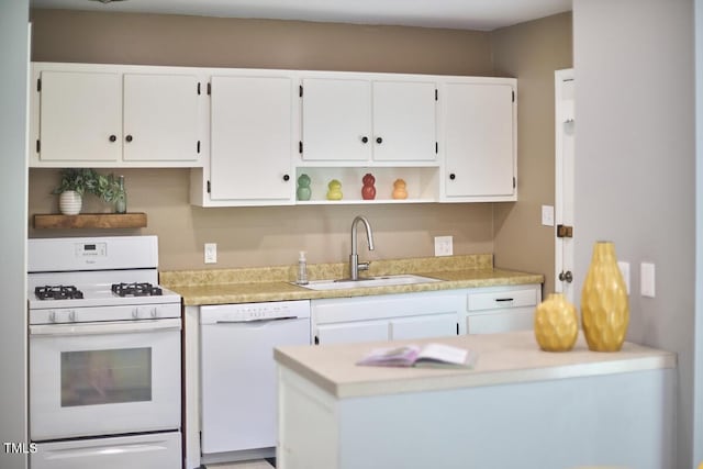 903 W Maynard Ave, Durham, NC 27704 - kitchen with white appliances, open shelves, white cabinetry, light countertops, and a peninsula