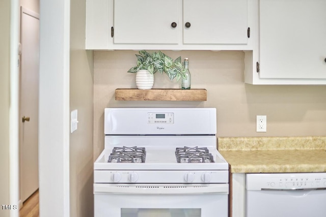 903 W Maynard Ave, Durham, NC 27704 - kitchen featuring white appliances, white cabinets, and light countertops