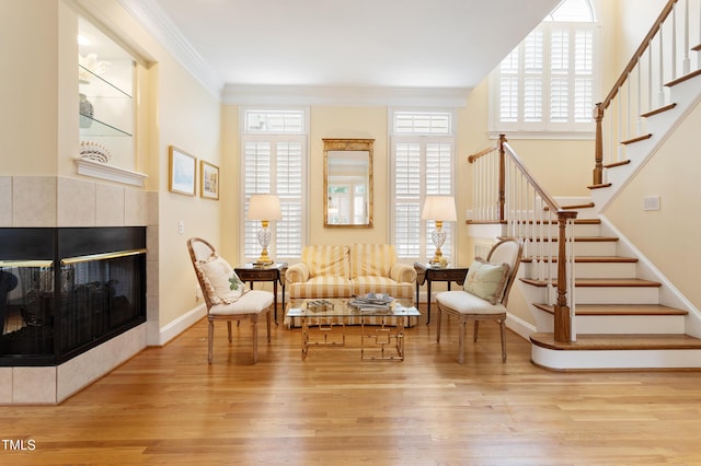 3928 Bentley Bridge Rd, Raleigh, NC 27612 - sitting room featuring stairs, wood finished floors, a fireplace, crown molding, and baseboards
