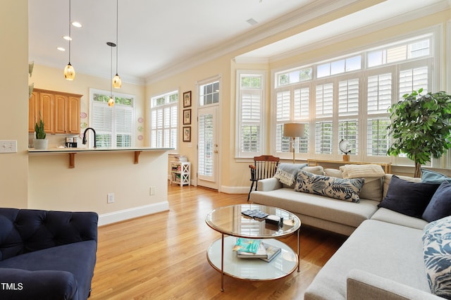 3928 Bentley Bridge Rd, Raleigh, NC 27612 - living room with ornamental molding, baseboards, light wood-style flooring, and recessed lighting