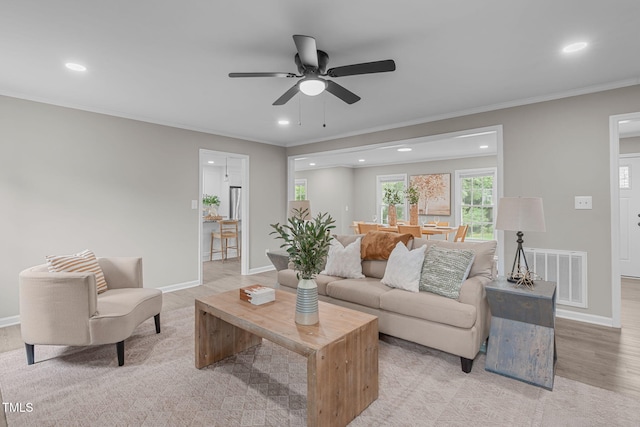 5804 Heathill Ct, Raleigh, NC 27603 - living room with recessed lighting, a ceiling fan, baseboards, crown molding, and light wood-type flooring