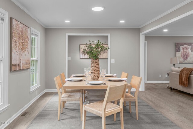 5804 Heathill Ct, Raleigh, NC 27603 - dining area featuring wood finished floors, recessed lighting, crown molding, and baseboards