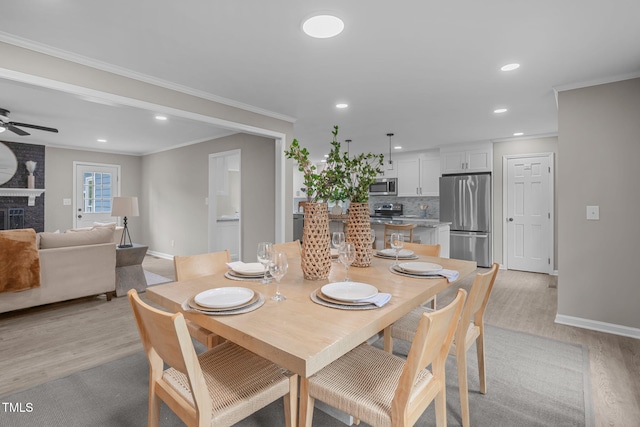 5804 Heathill Ct, Raleigh, NC 27603 - dining space with light wood-style floors, baseboards, recessed lighting, crown molding, and a ceiling fan
