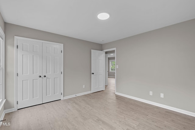 5804 Heathill Ct, Raleigh, NC 27603 - unfurnished bedroom with wood finished floors, baseboards, and a closet