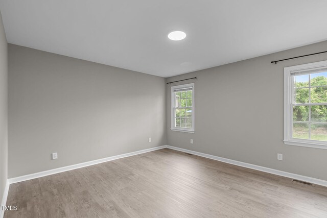 5804 Heathill Ct, Raleigh, NC 27603 - spare room featuring wood finished floors, plenty of natural light, and baseboards