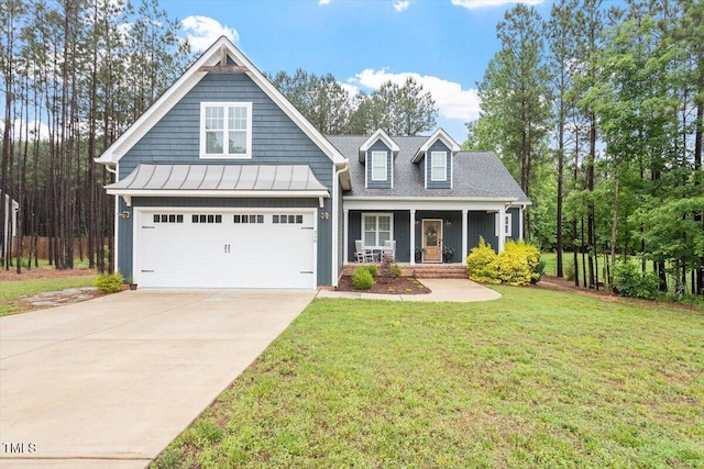 210 Sorrel Dr, Franklinton, NC 27525 - view of front of home with a porch, a front yard, a garage, driveway, and a standing seam roof