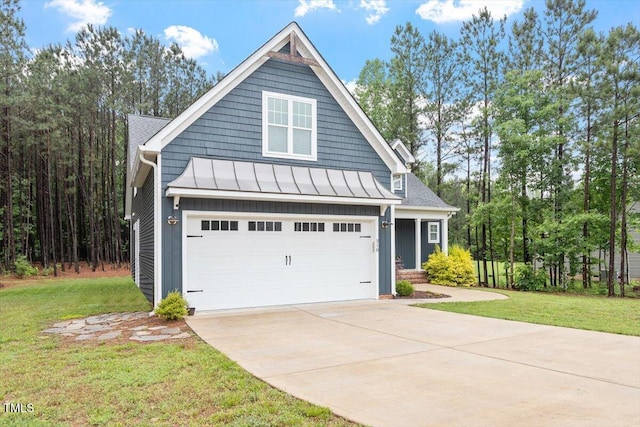 210 Sorrel Dr, Franklinton, NC 27525 - view of front of home featuring a standing seam roof, driveway, a front yard, and a garage