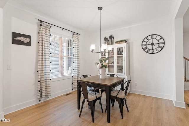 210 Sorrel Dr, Franklinton, NC 27525 - dining room with light wood-type flooring, a chandelier, baseboards, and ornamental molding