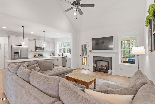 210 Sorrel Dr, Franklinton, NC 27525 - living room featuring recessed lighting, ceiling fan, light wood-type flooring, a fireplace, and baseboards